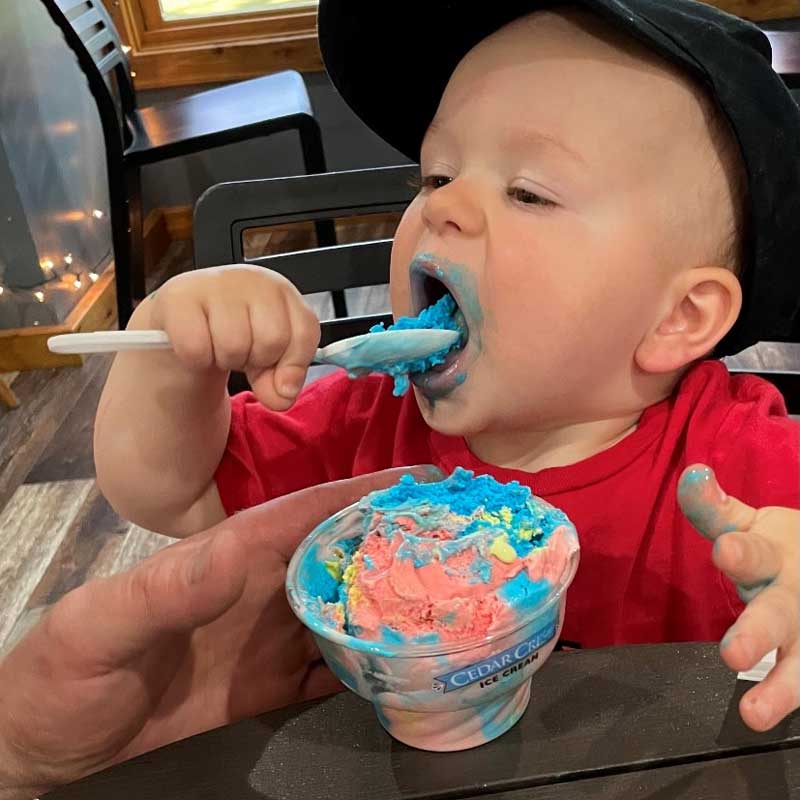 Baby eating Superman icecream